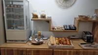 a kitchen with a counter with some pastries on it at Contact Hôtel Foch in Besançon