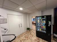 a large black refrigerator in a room at Contact Hôtel Foch in Besançon