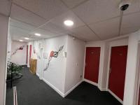 a hallway with two red doors in a room at Contact Hôtel Foch in Besançon