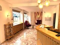 a large living room with a desk and a chair at Contact Hôtel Foch in Besançon