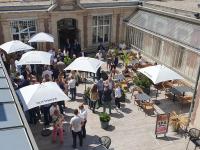 a group of people standing under umbrellas in a courtyard at Hôtel Spa Marotte in Amiens