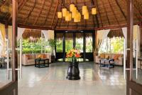 a lobby of a resort with a table with flowers on it at Hidden Beach Resort Au Naturel Adults Only Catamarán, Cenote & More Inclusive in Akumal