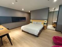 1 dormitorio con 1 cama grande, escritorio y mesa en Walker-Taoyuan, en Taoyuan