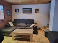 a living room with a couch and a coffee table at La petite Anfiane in Le Grand-Bornand