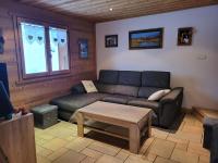 a living room with a couch and a coffee table at La petite Anfiane in Le Grand-Bornand