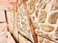 a stone wall in a room with a couch at ApartHotel Riviera - CCC OT Loft du Chateau Old Town Prom des Anglais in Nice