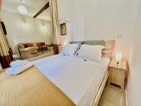 a bedroom with a large white bed and a couch at ApartHotel Riviera - CCC OT Loft du Chateau Old Town Prom des Anglais in Nice