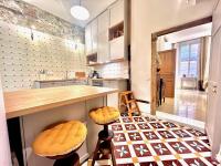 a kitchen with a counter and stools at ApartHotel Riviera - CCC OT Loft du Chateau Old Town Prom des Anglais in Nice