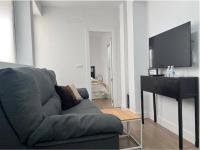 Televízia a/alebo spoločenská miestnosť v ubytovaní APARTAMENTO URQUÍA