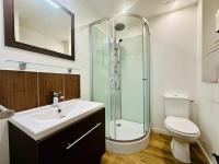a bathroom with a shower and a sink and a toilet at COZY - Appartement de charme proche thermes in Rochefort