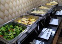 a buffet with three trays of food on a table at Hua Xiang Motel - Arena in Kaohsiung