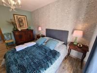 a bedroom with a bed with blue pillows at Guestroom Briare, 1 pièce, 2 personnes - FR-1-590-369 in Briare