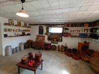 a room with a lot of items on the wall at Le Clos Fleuri in Caumont