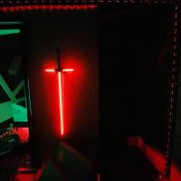 a red cross is lit up in a dark room at Hôtel Les Deux Porches in Verrières