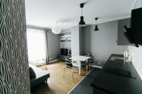 Televízia a/alebo spoločenská miestnosť v ubytovaní RENTTNER Apartamenty
