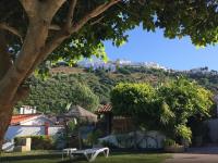 a park with a bench in front of a hill at Hotel El Paso in Vejer de la Frontera