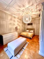 a bedroom with a bed and a chandelier at Les tonneliers in Strasbourg