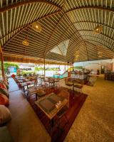 Habitación grande con mesas, sillas y piscina en Bathala Resort, en Panglao