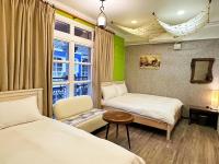 a hotel room with two beds and a window at Dot Minsu in Wujie