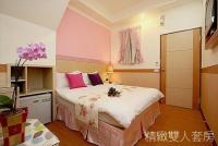a bedroom with a large bed with pink pillows at Hualien Hai Bin Homestay in Hualien City