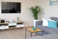 Televízia a/alebo spoločenská miestnosť v ubytovaní Aqua Cabana