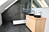 a bathroom with two sinks and a staircase at La Maison du Quai Triplex de charme 4 étoiles en hyper centre avec SPA in Landerneau