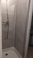 a shower with a glass door in a bathroom at STUDIO avec PARKING TOUT A PIED et CALME in Bandol