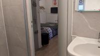 a bathroom with a sink and a bed in a room at STUDIO avec PARKING TOUT A PIED et CALME in Bandol