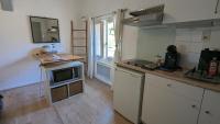 a kitchen with a sink and a microwave at STUDIO avec PARKING TOUT A PIED et CALME in Bandol