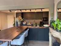 a kitchen with a wooden table and some plants at Superbe appartement haut de gamme centre ville in Le Mans