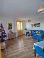 a living room with blue couches and a christmas tree at Grand appartement cosy-Hyper Centre-Place Verdun in Tarbes