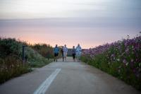 a group of people walking down a road with flowers at DOMAINE LE MEZO in Ploeren