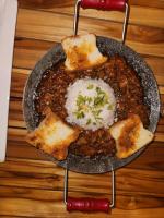 a pan full of food with bread and beans at Cappadocia Hotel in Nungwi