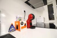 a kitchen counter with a red appliance on a counter top at Bel appartement meublé 4 pièces in Ris-Orangis