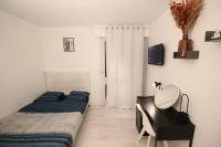 a bedroom with two beds and a desk with a desk at Bel appartement meublé 4 pièces in Ris-Orangis