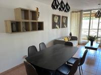 a dining room with a black table and chairs at TAN&#39;MAYEVA APPART * in Mamoudzou