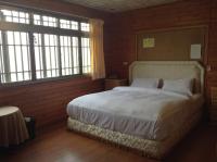 a bedroom with a bed and two windows at Bunbury Fruit Ranch B&amp;B in Ren&#39;ai