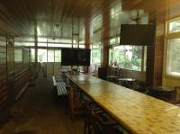 a room with a large bar with tables and chairs at Bunbury Fruit Ranch B&amp;B in Ren&#39;ai