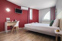a bedroom with a bed and a red wall at Hotel L&#39;Abri in Le Puy-en-Velay