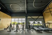 a gym with treadmills and elliptical machines at ARCA Resort 