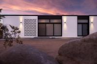 a large white building with lights on the side of it at Neutra Home Joshua Tree Luxury Retreat Pool and Spa in Joshua Tree