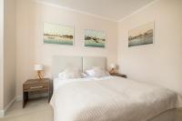 Łóżko lub łóżka w pokoju w obiekcie Apartamenty Aquamarina by Noclegi Renters