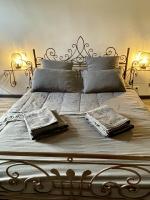 a bed with two pillows and a metal frame at Le Taurillou 