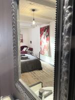 a mirror reflection of a bedroom with a bed at Le Taurillou 