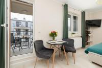 Telewizja i/lub zestaw kina domowego w obiekcie Apartamenty Aquamarina by Noclegi Renters