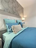 a blue bed with pillows on top of it at &#39;&#39;Les Platanes&#39;&#39;de Miss.K Conciergerie in Gorrevod