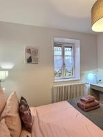 a bedroom with a bed and a window at &#39;&#39;Les Platanes&#39;&#39;de Miss.K Conciergerie in Gorrevod