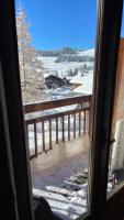 a view from a window of a balcony with snow at APPARTEMENT PLEIN SUD AUX SAISIES N°6 in Les Saisies