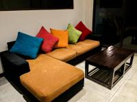 a living room with a couch with colorful pillows at The Aurelia in Gampola
