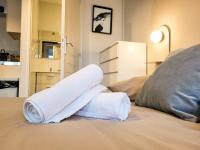 a pile of towels sitting on top of a bed at Suite Oxymore in Lyon